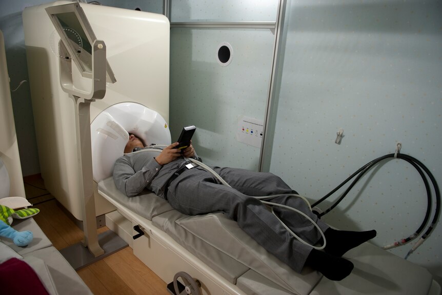 Person in a magnetoencephalography (MEG) machine 