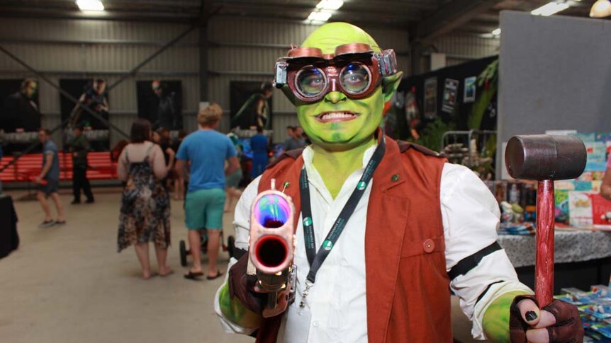 Man painted green with a hammer and goggles on