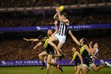 Collingwood's Mason Cox flies to take a mark against Richmond in the preliminary final