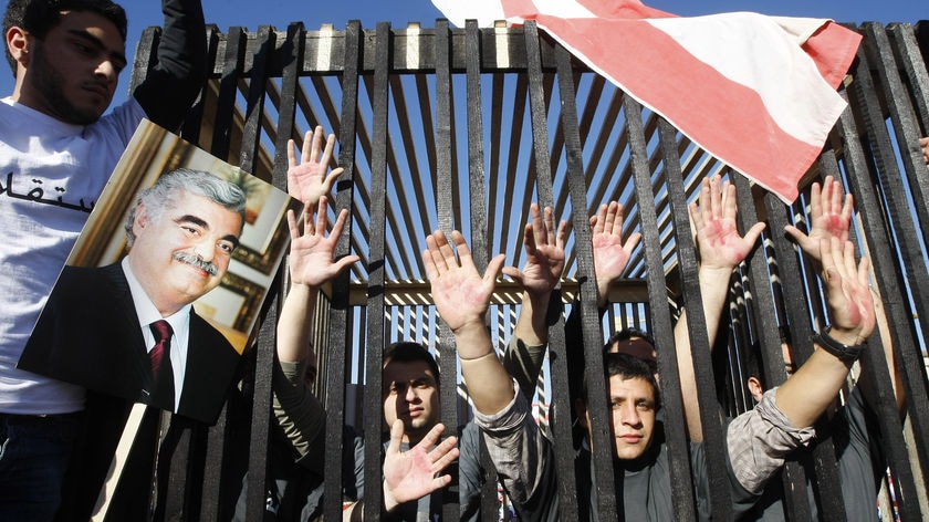 Lebanese youths stand in a makeshift mock-prison cell to represent Hariri' killers.