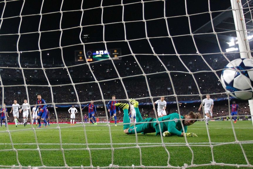 Barcelona's Lionel Messi (foreground) scores a Champions League penalty past PSG keeper Kevin Trapp.