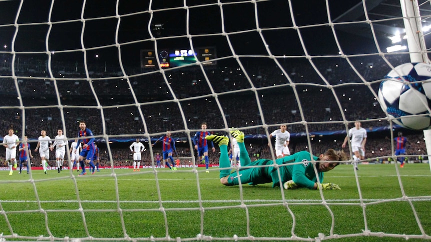 Barcelona's Lionel Messi scores a Champions League penalty past PSG keeper Kevin Trapp.