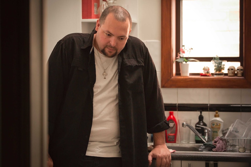 Christian Read leans against the kitchen bench.