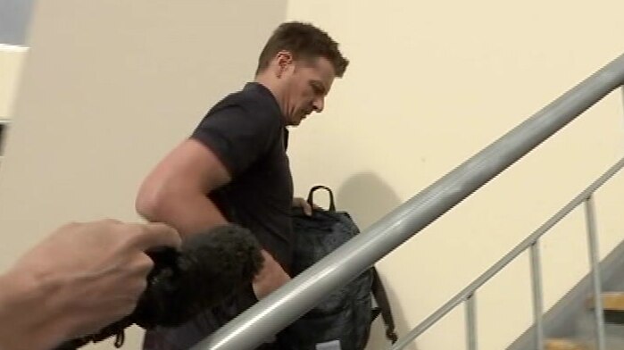 Mr Arnold makes no comment to media as he walks up stairs to his chiropractic practice.
