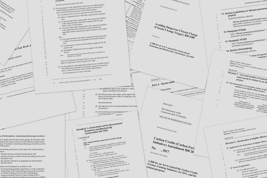 Pages of bills relating to climate policy are scattered across the screen.