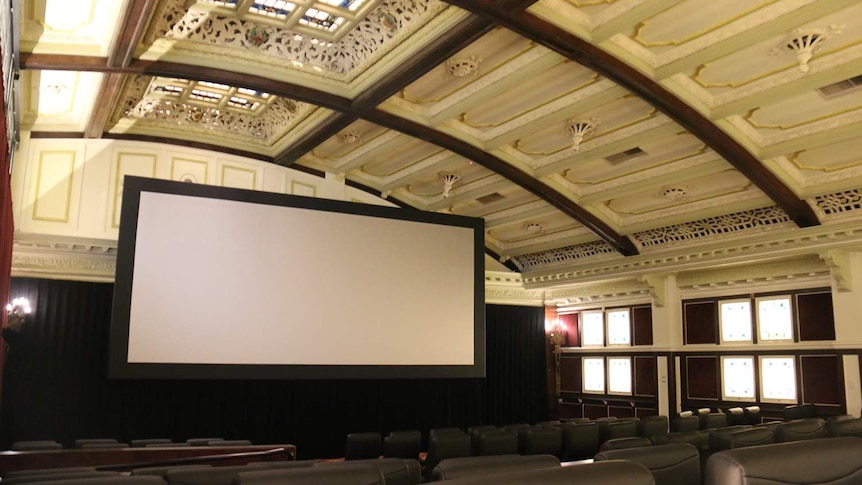 Movie screen, theatre and soaring decorative ceiling of Elizabeth Picture Theatre in Brisbane's CBD