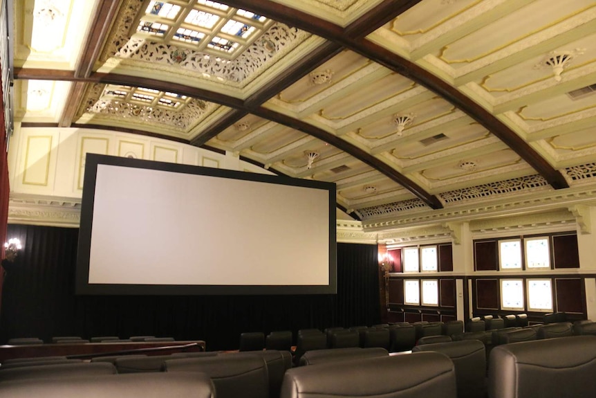 Movie screen, theatre and soaring decorative ceiling of Elizabeth Picture Theatre in Brisbane's CBD