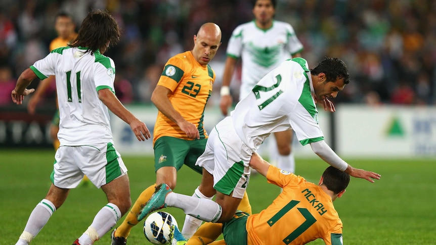 Bresciano scraps for the ball against Iraq