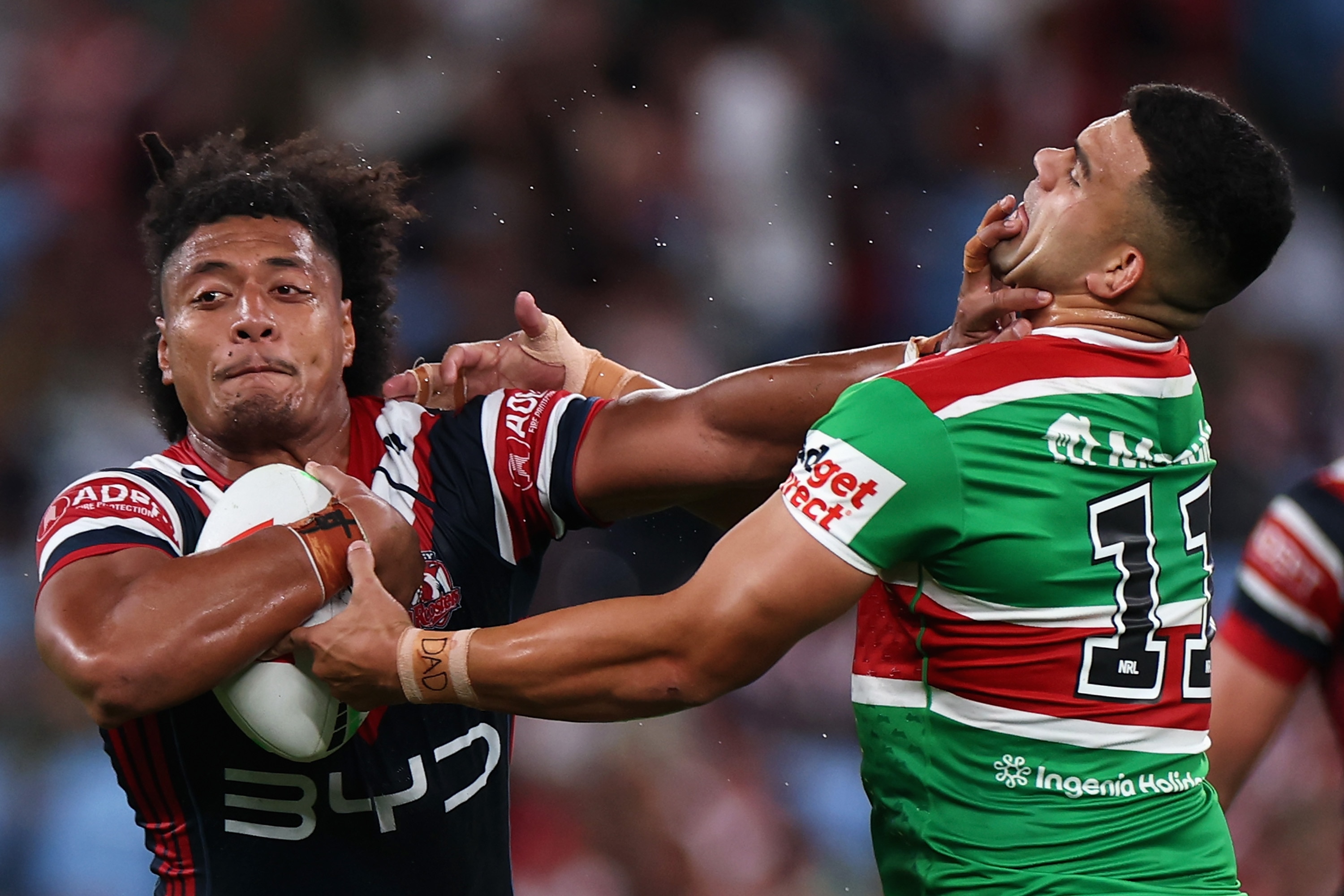 A man fends off another man during a rugby league match 