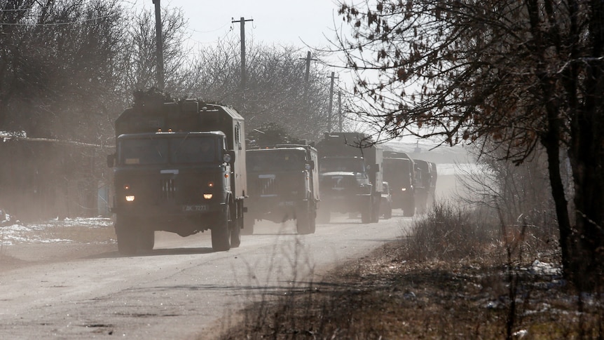 Russian military trucks spraypainted with the notorious 'Z" symbol roll into a town in Donetsk, March 12, 2022.
