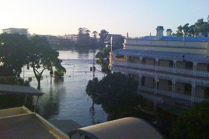 Sun rises over floodwaters lapping at the Regatta Hotel on Coronation Drive at Toowong in Brisbane on January 13, 2011.
