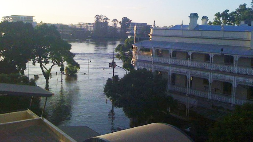 Sun rises over floodwaters lapping at the Regatta Hotel on Coronation Drive at Toowong in Brisbane on January 13, 2011.