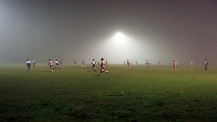 Fog invades the field during an Aussie Rules game in Moorooka on Brisbane's southside, on July 7, 2017