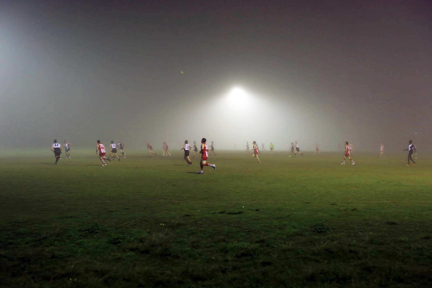 Fog invades the field during an Aussie Rules game in Moorooka on Brisbane's southside, on July 7, 2017
