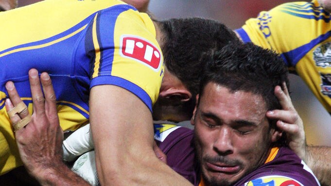 Justin Hodges is tackled