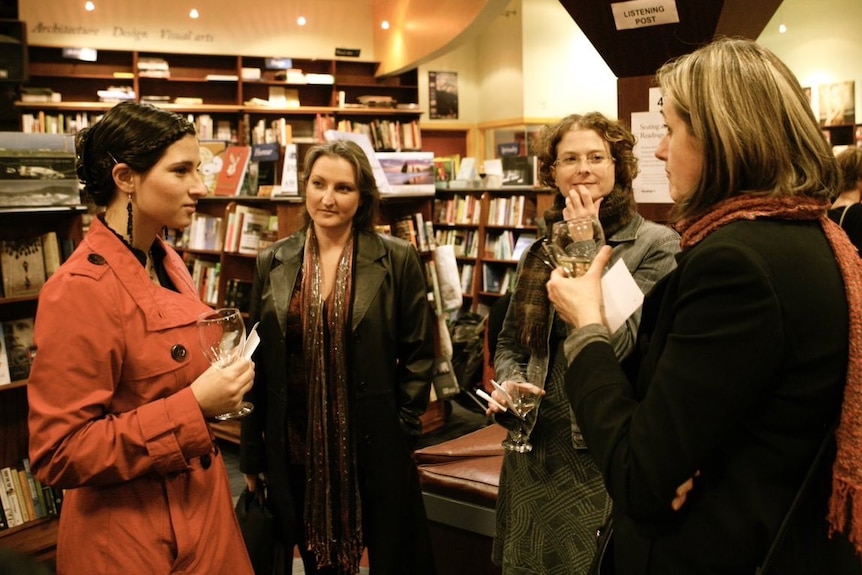Women chatting in book shop, pictured in obituary for YA author Steph Bowe