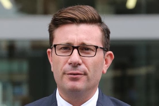 a man stands outside court