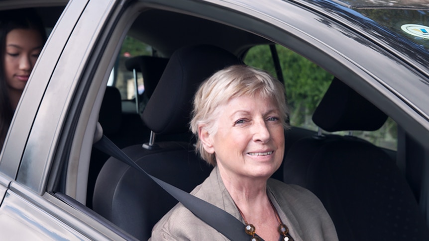 Elderly woman driving a passenger.