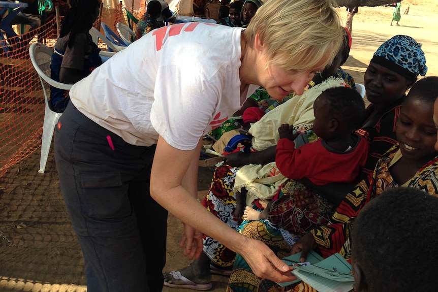 Ms Halls-Smith checks the patient records of those waiting for vaccinations.