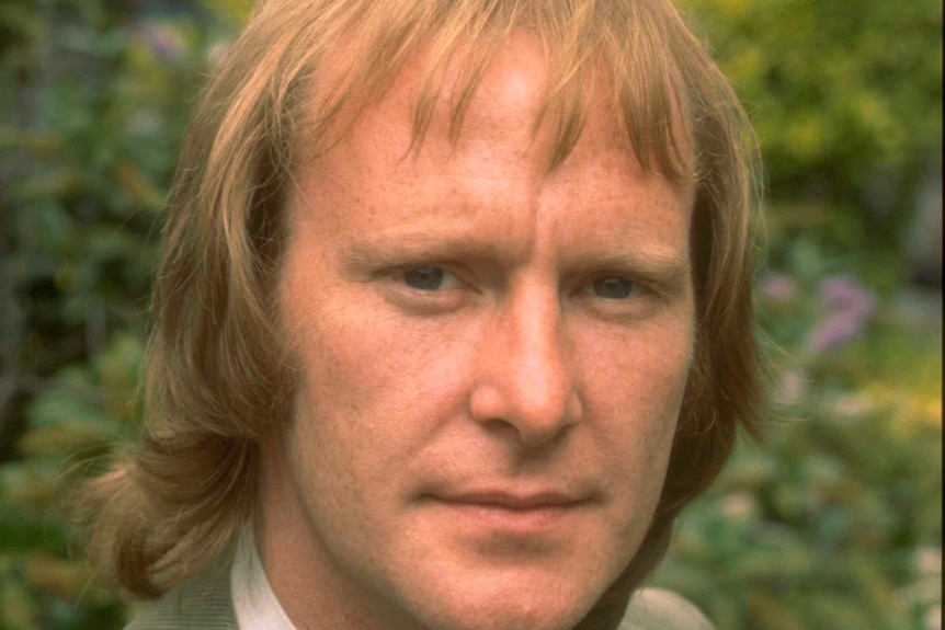 Dennis Waterman looks directly at the camera with a neutral expression.