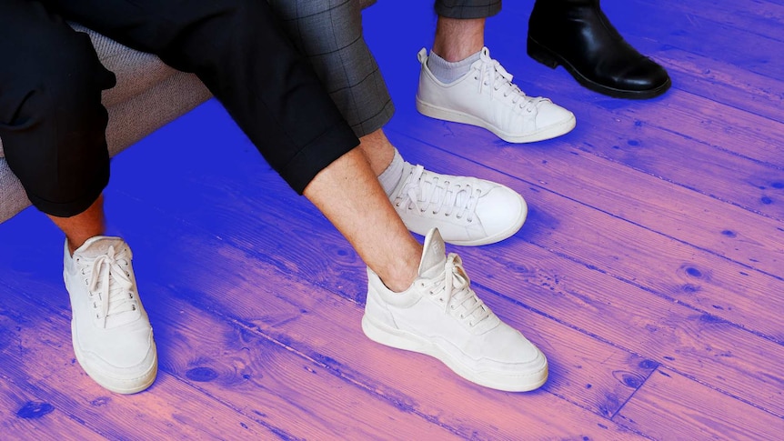 Close-up of people wearing white sneakers and black boots in a story about looking after food health while working from home.