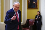 US Senate Majority Leader Chuck Schumer gives a thumbs up and smiles. 