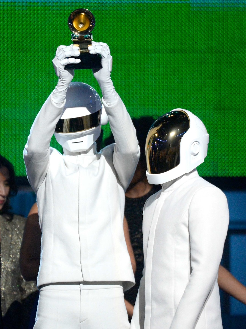 Daft Punk accept the Album of the Year award at the Grammys in Los Angeles.