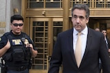 Michael Cohen leaves court after pleading guilty surrounded by police