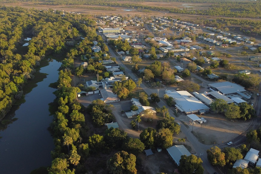 A small, outback town with a creek running through at sunset