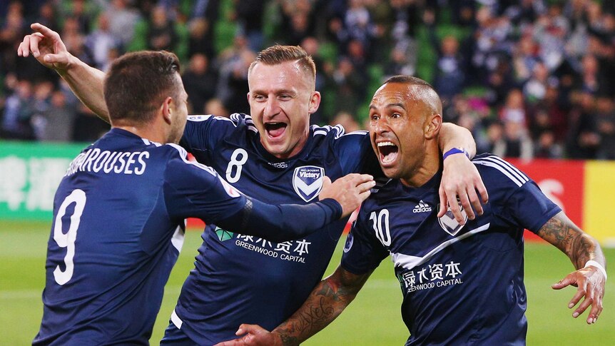 Archie Thompson of the Victory (R) celebrates a goal with Besart Berisha and Kosta Barbarouses (L) during the AFC Champions League match