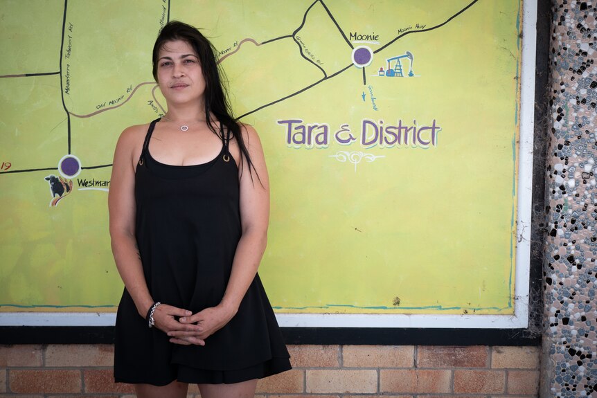 Tara local Stephanie Pedron standing near a mural on the street at Tara, Queensland, December 2022. 
