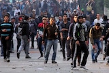 Muslim Brotherhood supporters clash with Egyptian government supporters (unseen) in Cairo