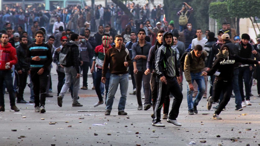 Muslim Brotherhood supporters clash with Egyptian government supporters (unseen) in Cairo