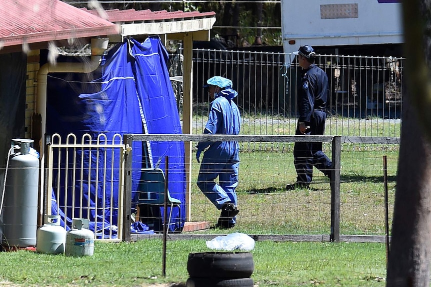 A Police forensic officer walks around the foster home of Queensland schoolgirl Tiahleigh Palmer