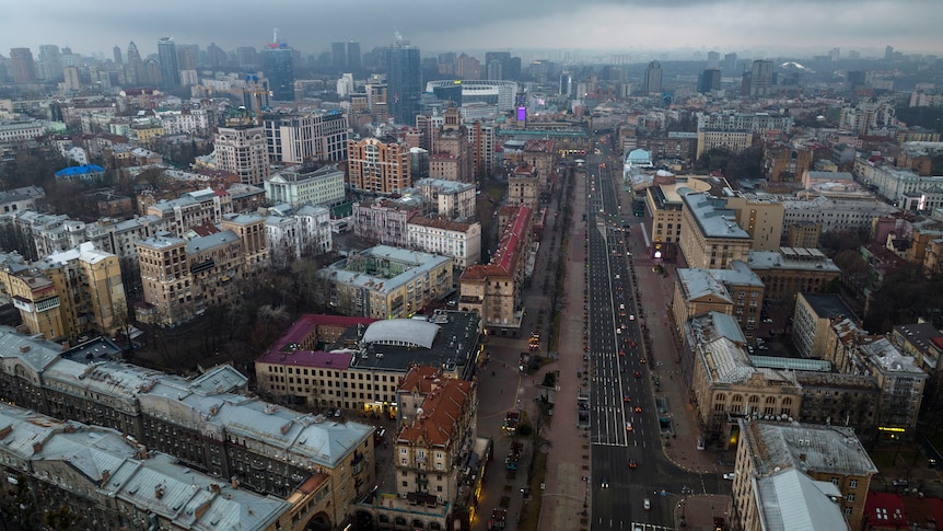 A birds eye view of a city with clouds above