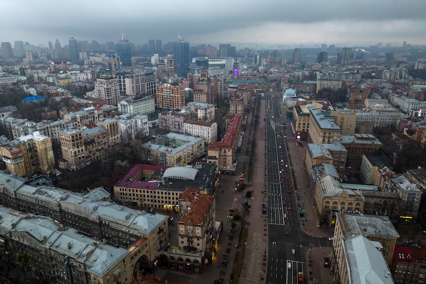 A birds eye view of a city with clouds above