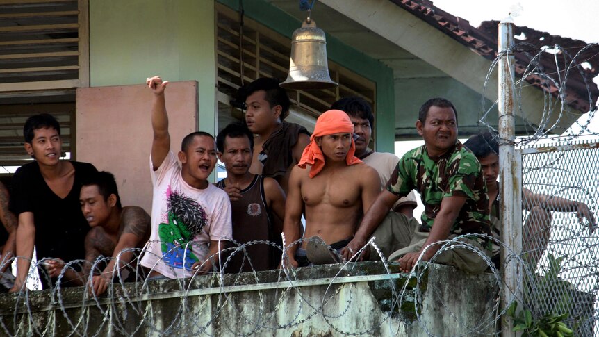 Prisoners occupy a tower during a riot at Kerobokan prison on Bali.