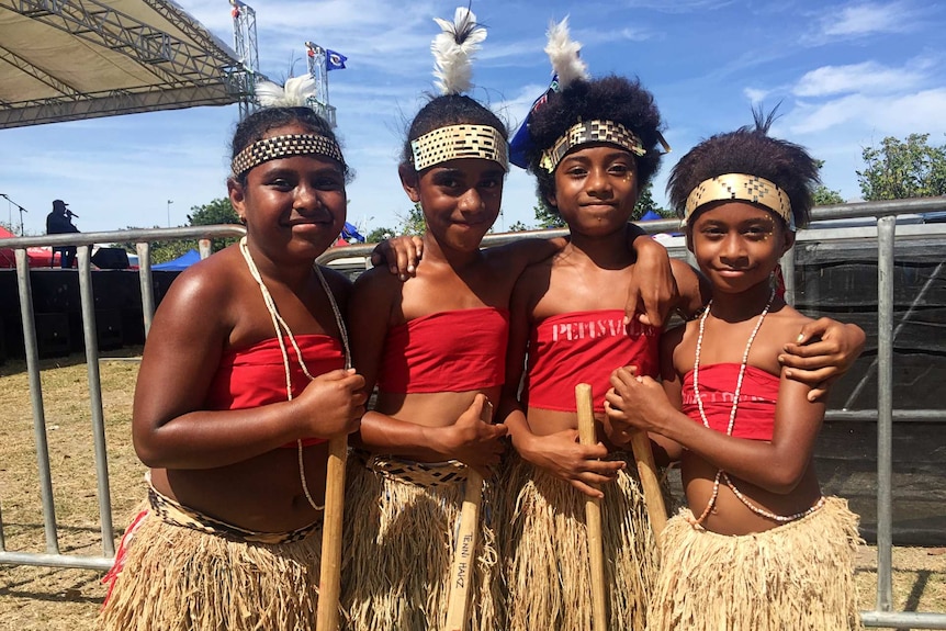 Girls wearing traditional headdresses and grass skirts at Bougainville Day in Port Moresby.