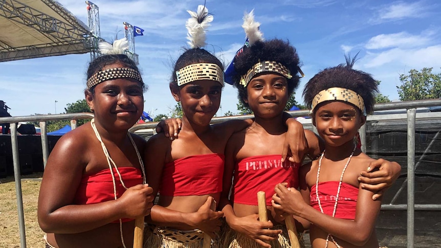 Girls wearing traditional headdresses and grass skirts at Bougainville Day in Port Moresby.