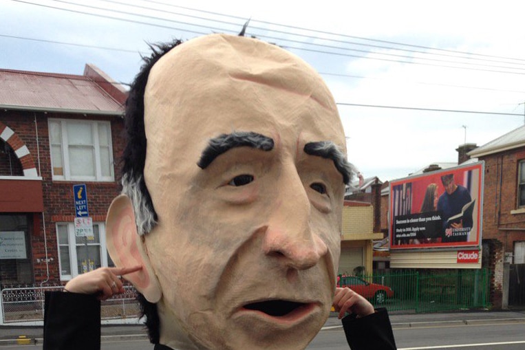 Protester wearing an oversize Andrew Nikolic head