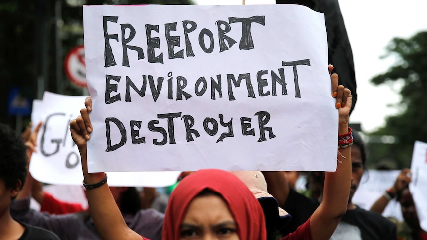 A student calls for the closure of Freeport's mine in the Papua province.
