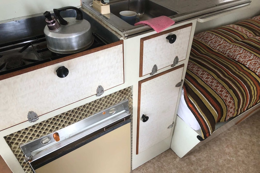 Shot of the fridge inside Claude Harris' van with vents around it