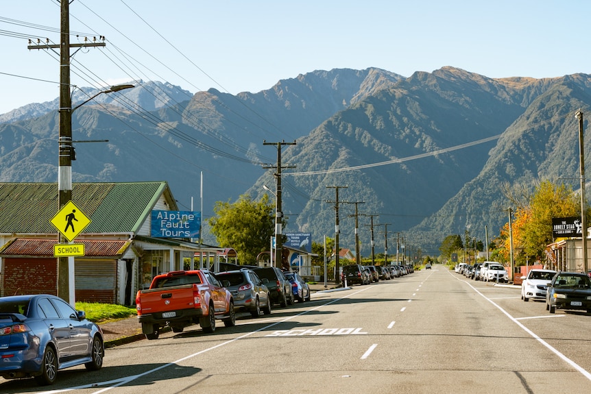 A high street of a small town, with one business called Alpine Fault Tours visible 