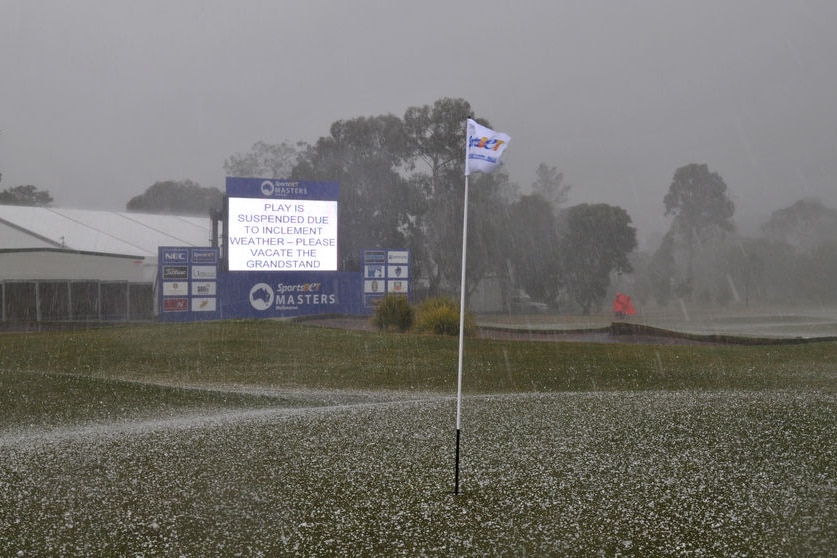 Hail engulfs the 18th green at Huntingdale at the end of the first day's play of the Masters