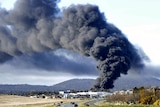 A pillar of black smoke rises from a chemical fire in the industrial suburb of Mitchell in Canberra