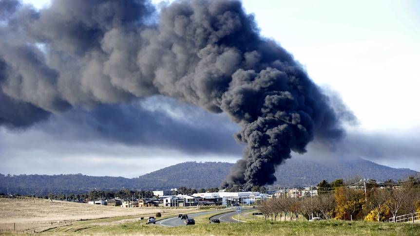 A pillar of black smoke rises from a chemical fire in the industrial suburb of Mitchell in Canberra