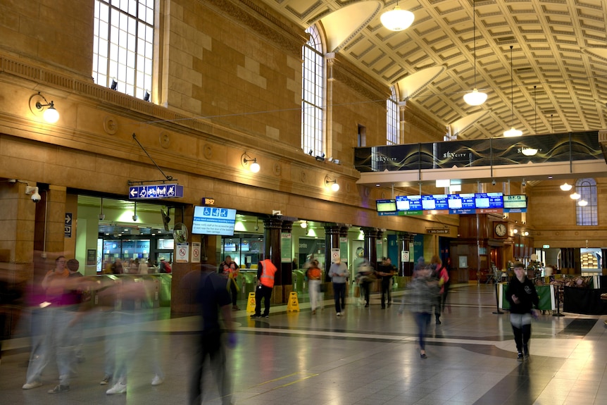 Passengers and pedestrians move through Adelaide Railway Station.