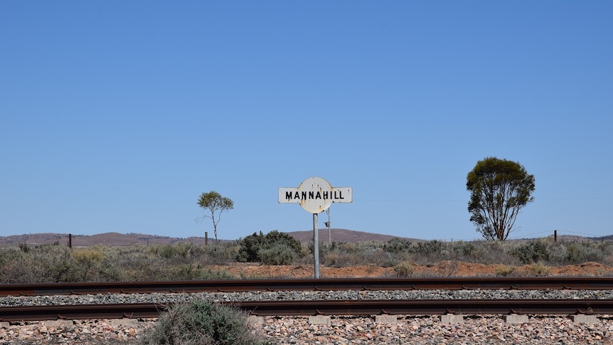 Trainline and railway sign for Mannahill in outback South Australia
