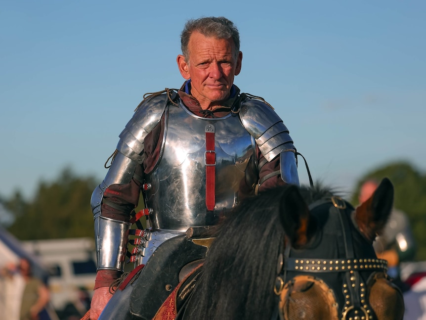 A knight in armour on horseback