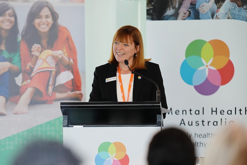 Carolyn Nikoloski is dressed formally while giving a speech on Mental Health Australia's Parliamentary Advocacy Day.